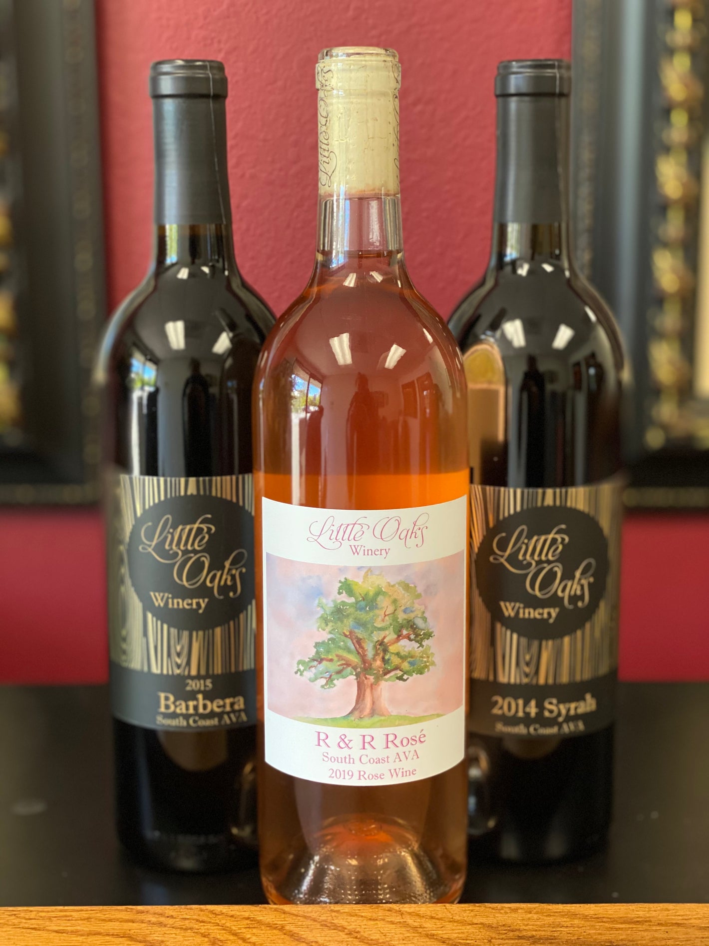 three wine bottles, a rose and two red wines, as featured in our standard wine club 